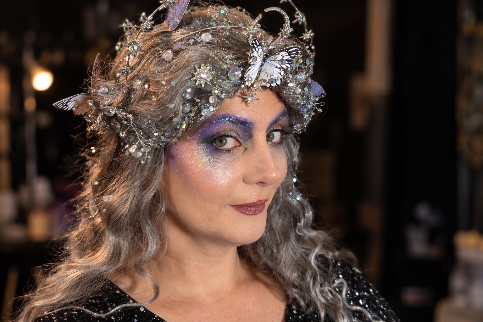 A finished character look with silver hair, celestial details, and butterfly adornments